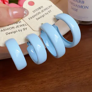 Detailed macro view of baby blue spray-painted hoop earrings with S925 silver needles