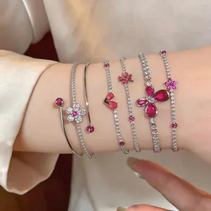 Close-up of luxury zircon bracelets featuring butterfly and floral motifs on wrist