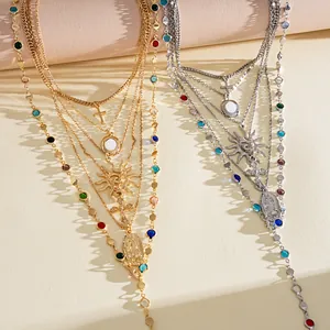 Detailed view of vintage layered necklaces with cross and sun charms in gold and silver.