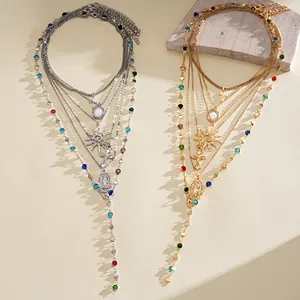 Detail of multi-layer retro necklaces with cross and sun charms in gold and silver finishes