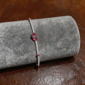 Close-up of French luxury zircon bracelet with red heart stones on jewelry roll