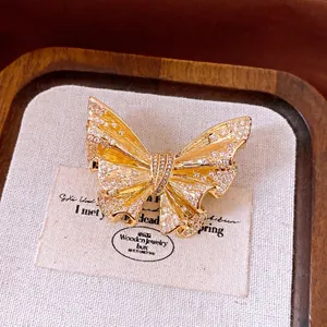 Elegant 18k gold-plated butterfly brooch with shimmering stones for a luxury aesthetic