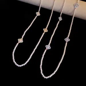 Close-up of elegant pearl necklace with zircon flower charms and retro vintage finish