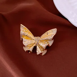 Detailed macro shot of 18k gold plated butterfly brooch encrusted with sparkly crystals
