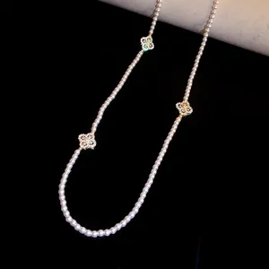 Elegant pearl beaded necklace featuring sparkling zircon flower charms in a close-up view