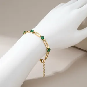 Gold-tone 304 stainless steel paperclip bracelet featuring square-cut emerald green zircons