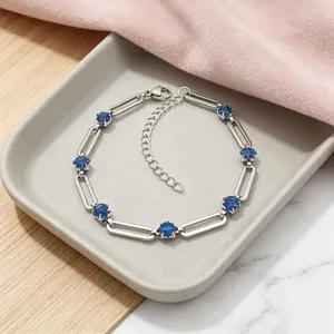 Detailed view of silver stainless steel paperclip bracelet with blue star zircon stones
