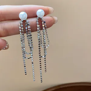 Eleganti orecchini a nappa d'argento con perle bianche e catene geometriche lucide.