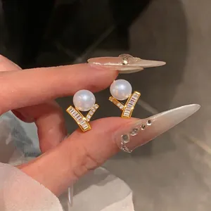 Elegant French style pearl stud earrings with zircon encrusted gold geometric base for women