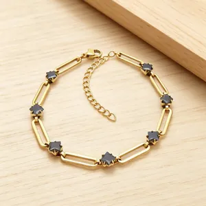 Detail view of 304 stainless steel paperclip bracelet with black star-shaped stones.