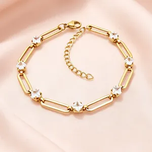 Macro shot of gold stainless steel paperclip chain bracelet with clear square zircons