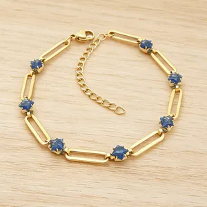 Macro detail of 304 stainless steel gold paperclip bracelet with blue rhombus stones
