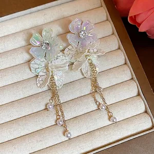 Elegant pearlescent acrylic flower earrings with long gold chain pearl tassels