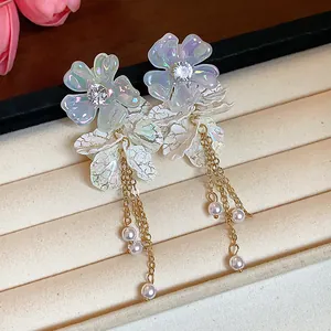 Detail showing iridescent acrylic flowers and pearl tassels of the sweet style earrings