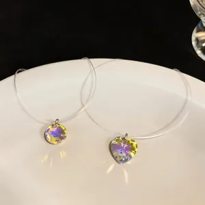 Detail of iridescent heart and round crystal pendants on invisible fishing line chains.