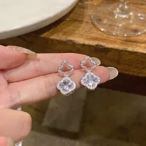 Detailed view of elegant silver flower stud earrings with sparkling cubic zirconia.