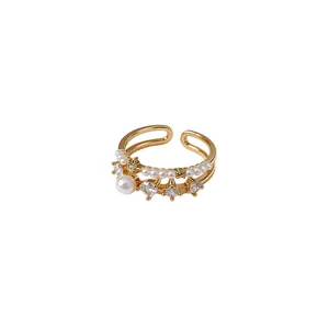 Vintage double-layer open ring with white pearls and clear zircon gemstones on white background