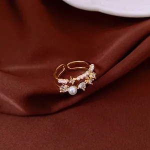 Detailed macro view of a vintage gold double-layer open ring with pearls and zircons