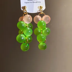 Detail view showing the translucent resin beads of these green grape cluster drop earrings