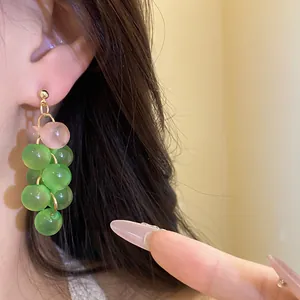 Detail of resin grape-like bead drop earrings with green and pink translucent pearls