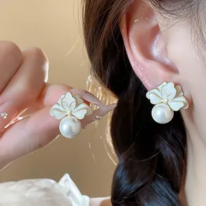 Detail view of French floral enamel earrings with elegant pearls and hypoallergenic silver needles