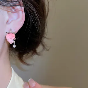 Nahaufnahme eines süßen rosa Erdbeer-Ohrsteckers aus Harz mit einem Kristall-Wassertropfen