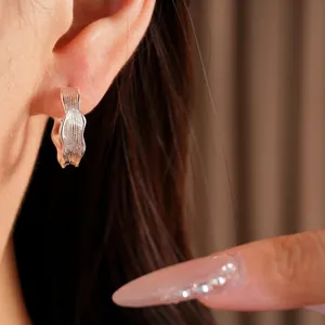 Elegant 18k gold plated textured hoop earrings with a minimalist wrinkled design