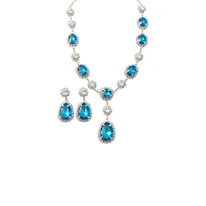 Luxurious jewelry set featuring blue teardrop and oval crystals with silver finish