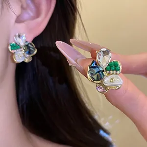 Exquisite floral stud earrings with crystals and pearl details on silver needles