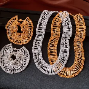 Close-up of vintage pleated ruffle jewelry set in gold and silver tones with magnetic clasp.