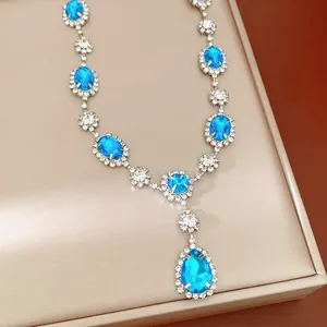Close-up detail of a vintage court style necklace with blue crystals and clear gems