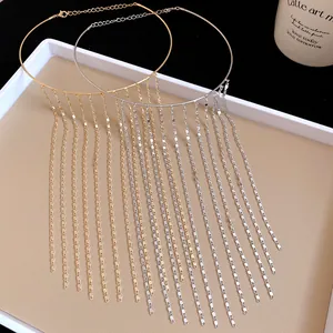 Detail shot of elegant metallic gold and silver chain tassel choker necklaces on a tray