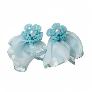 Elegant light blue chiffon flower stud earrings with pearl centers and beaded petals