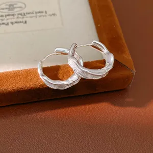 Detail shot of 18k gold plated earrings with unique wrinkled texture design