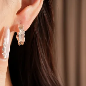 Macro view of elegant silver hoop earrings featuring a unique wrinkled texture design