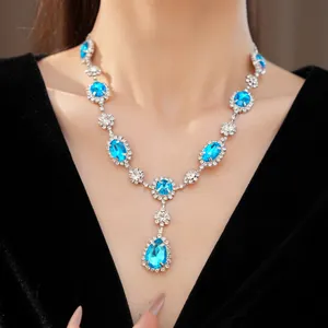 Exquisite blue teardrop gemstone necklace worn by a model in palatial luxury style.