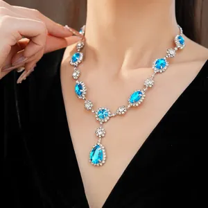 Detail shot of a luxury blue rhinestone necklace with vintage teardrop pendant design