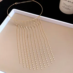 Detailed view of elegant gold metal chain tassel choker featuring long flowing fringe