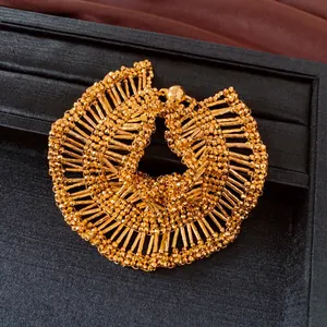 Detailed close-up of a gold pleated ruffled necklace featuring a vintage magnetic clasp