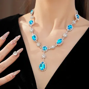 Luxurious blue crystal teardrop necklace set with elegant oval gems on a fashion model
