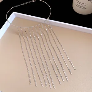Elegant detail of silver metal tassel choker necklace with long hanging fringe chains