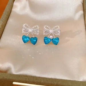 Elegant silver cherry bowknot stud earrings with blue heart crystals and pearls in box