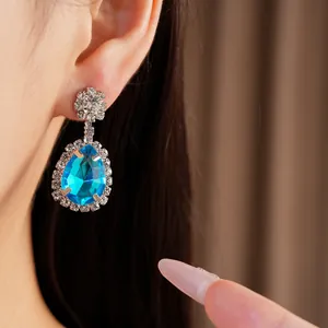 Detailed view of elegant vintage waterdrop earrings featuring bright blue rhinestones