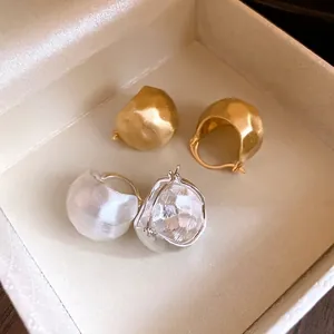Vintage style brushed matte gold and silver semi-circular hoop earrings displayed in box