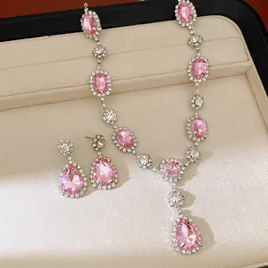 Elegant jewelry set featuring a pink rhinestone teardrop necklace and matching earrings