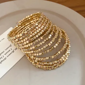 Vintage gold-toned multi-layer wrap bracelet featuring small square beads for elegant women