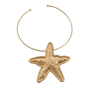 Bohemian style gold starfish pendant necklace featuring a minimalist torque wire choker chain