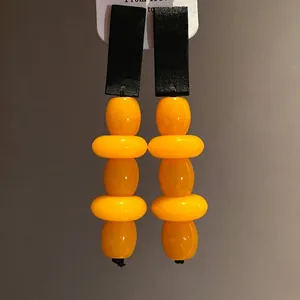 Vintage style black wood and yellow resin beaded drop earrings with elegant design