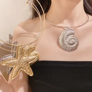 Detailed close-up of bohemian starfish and shell pendant necklace on female model