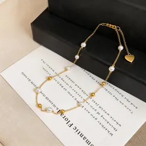 Elegante Perlenkette im französischen Stil mit Goldperlen und Herzanhänger Damen.
